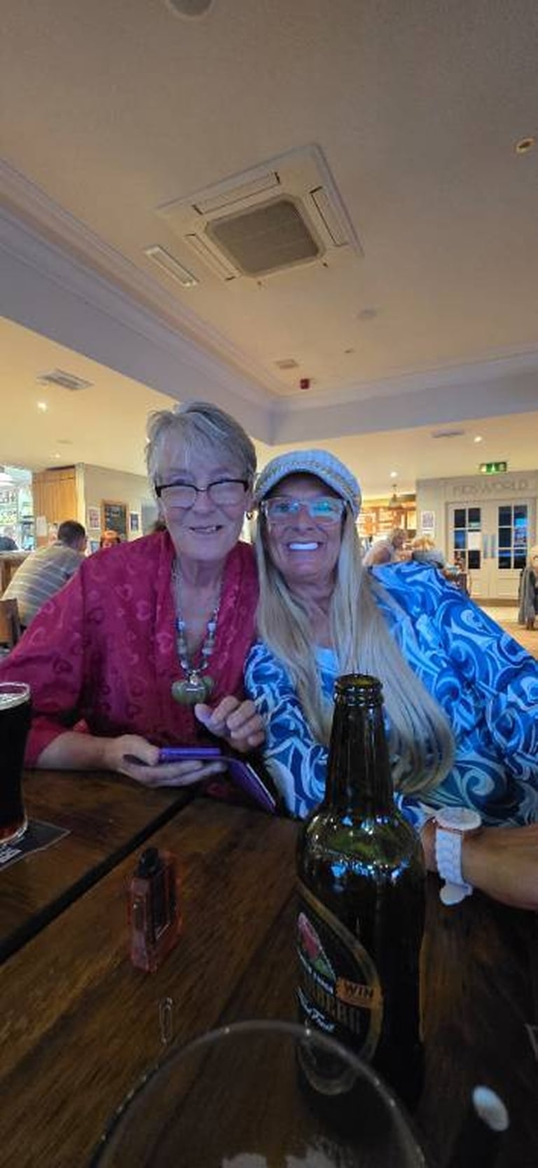 Two party guests smiling together