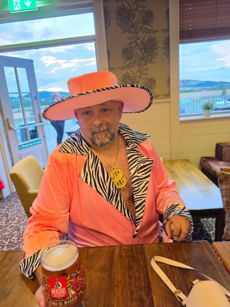 Guest in a pink seventies costume